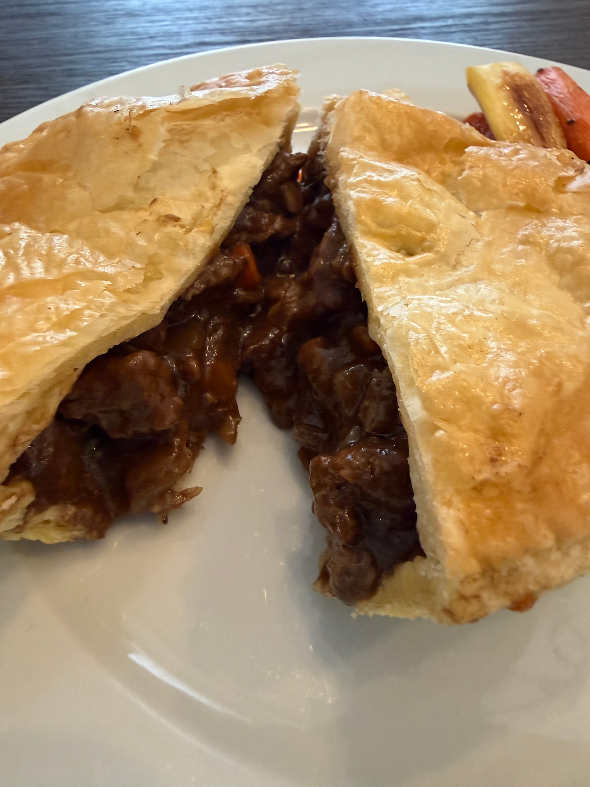 A golden savory pie cut open to show its rich meat filling